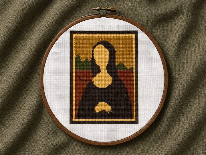 Golden Mona Lisa cross stitch pattern displayed in a wooden embroidery hoop