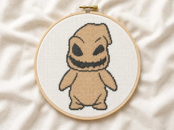 Cute boogeyman cross stitch pattern stitched and shown in an embroidery hoop