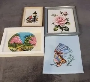 Four framed cross stitch pieces finished by a Clover Stitchery customer