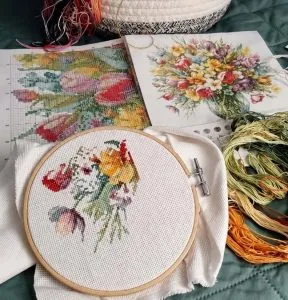 Wildflower cross stitch pieces and threads laid out by a customer